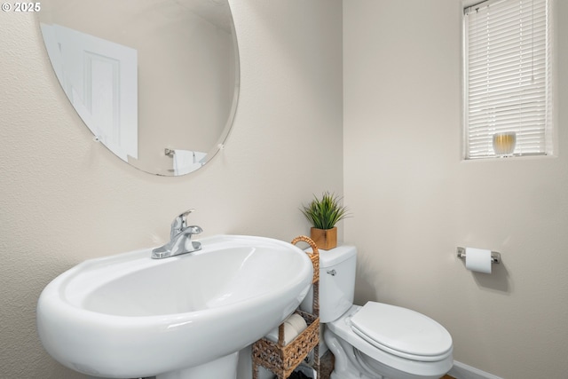 bathroom featuring toilet and sink