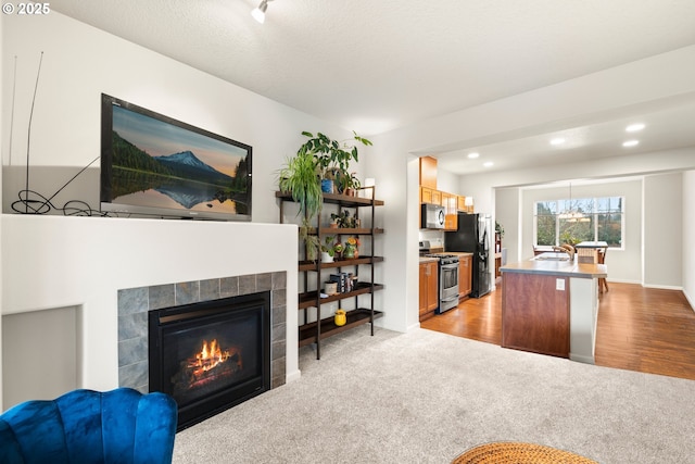 carpeted living room with sink and a fireplace