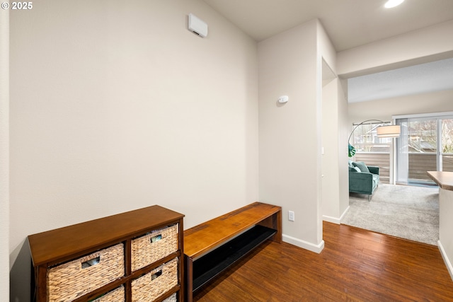 corridor with dark hardwood / wood-style flooring