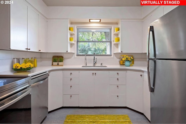 kitchen with sink, appliances with stainless steel finishes, decorative backsplash, and white cabinets