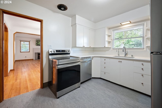 kitchen featuring white cabinetry, stainless steel appliances, sink, and plenty of natural light