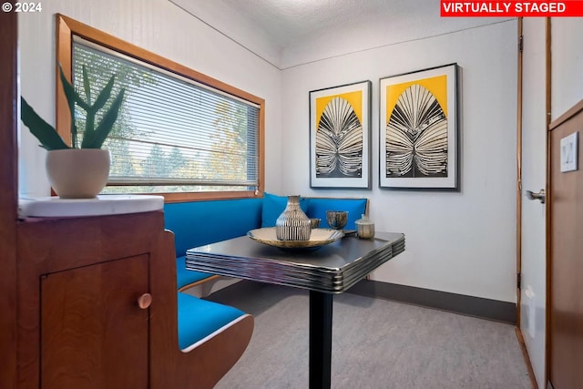 carpeted home office featuring a textured ceiling