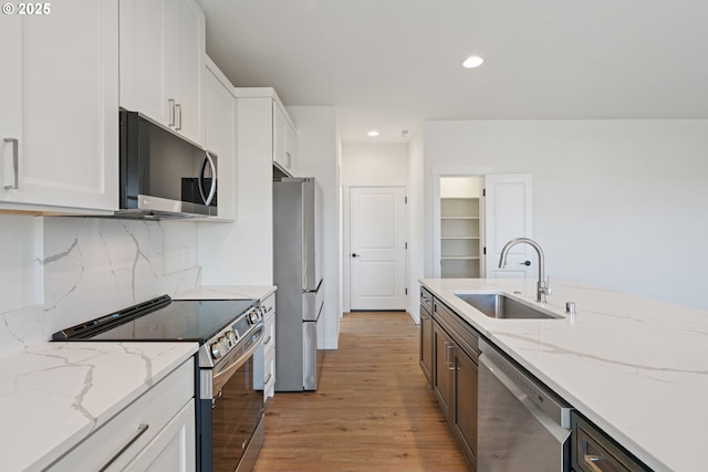11116 NE 91st Ave, Vancouver, WA 98662 - kitchen featuring a sink, light wood finished floors, white cabinets, and stainless steel appliances