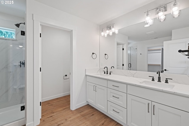 11116 NE 91st Ave, Vancouver, WA 98662 - full bathroom with double vanity, a sink, a marble finish shower, and wood finished floors