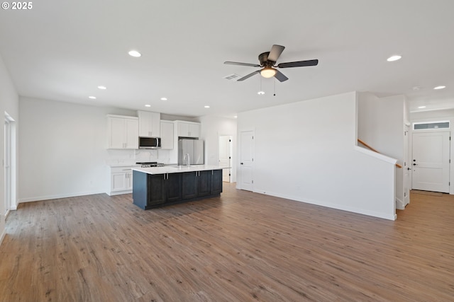 11116 NE 91st Ave, Vancouver, WA 98662 - kitchen with light countertops, a kitchen island with sink, stainless steel appliances, open floor plan, and white cabinetry