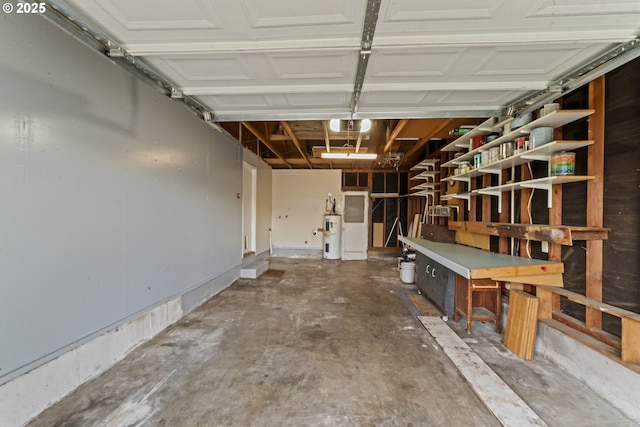 garage with electric water heater and a garage door opener