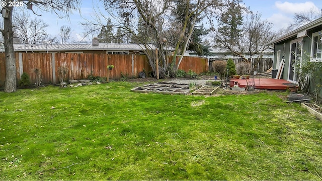 view of yard with a fenced backyard and a vegetable garden