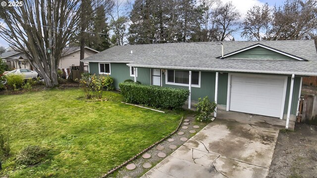 single story home featuring a garage and a front yard