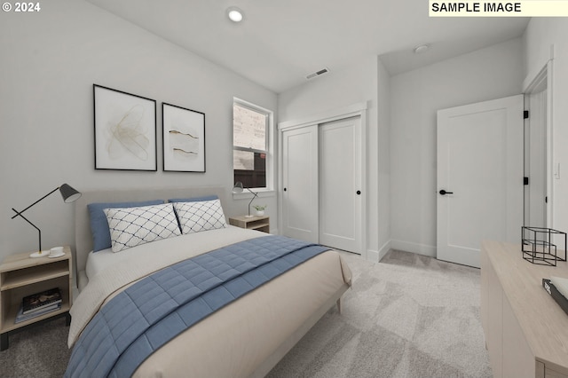 bedroom featuring light carpet and a closet