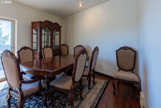 dining area featuring hardwood / wood-style flooring and a baseboard heating unit