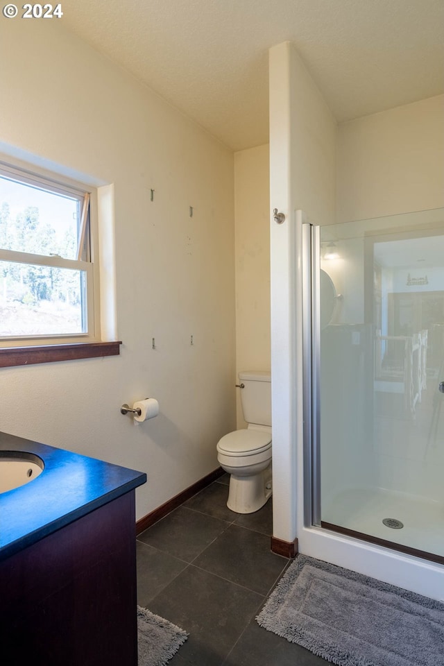 31367 Clarks Creek Rd, Mount Vernon, OR 97865 - bathroom with baseboards, a shower stall, toilet, vanity, and tile patterned floors