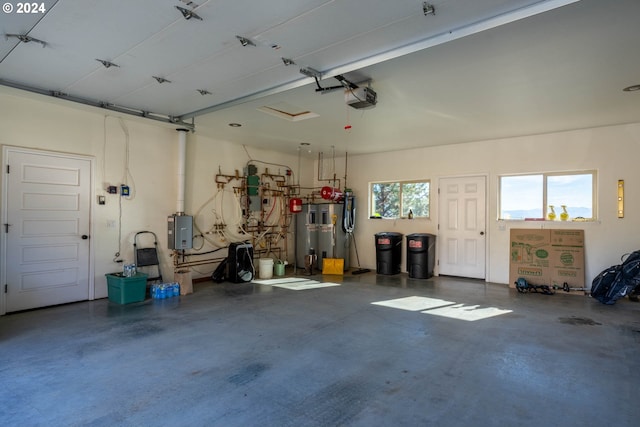 garage with a garage door opener, electric panel, and water heater