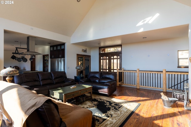 living room featuring hardwood / wood-style floors and high vaulted ceiling