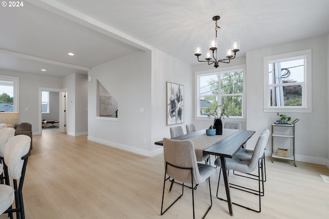 dining room featuring a notable chandelier and light wood-type flooring