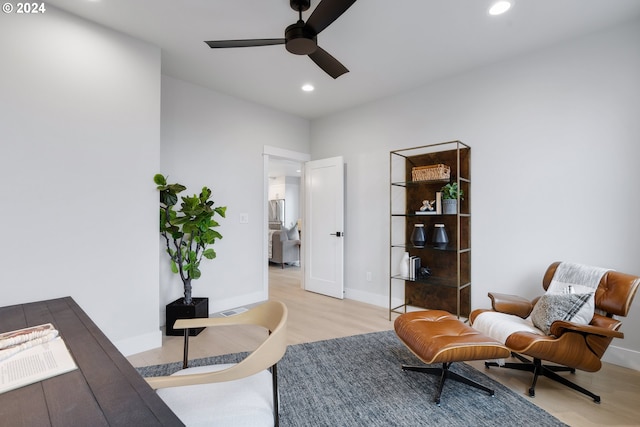 living area featuring ceiling fan and light wood-type flooring