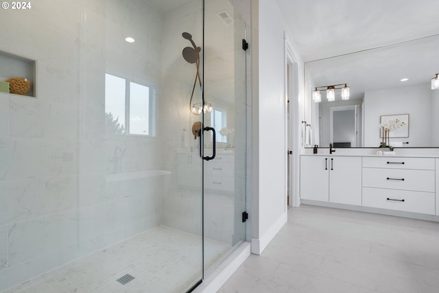 bathroom featuring an enclosed shower and vanity