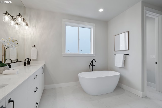 bathroom featuring a bath and vanity