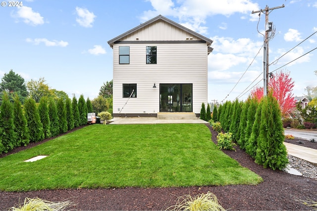 back of house with a yard and a patio area