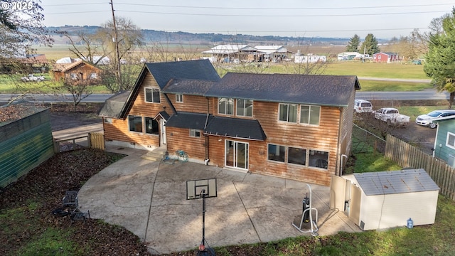 back of property featuring a shed and a patio area