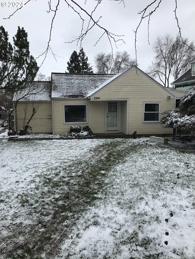 view of snow covered rear of property