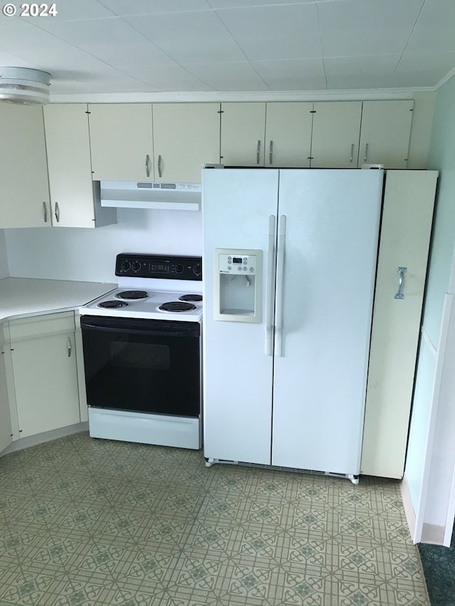 kitchen featuring electric range oven, white refrigerator with ice dispenser, and white cabinets