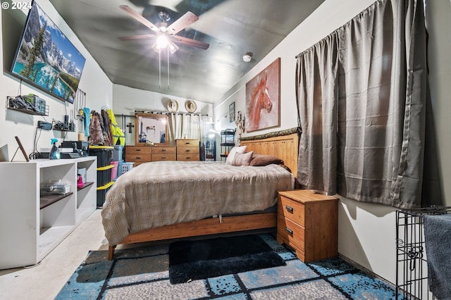 bedroom with ceiling fan and concrete flooring