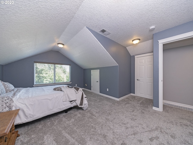 bedroom featuring a textured ceiling, carpet, and vaulted ceiling