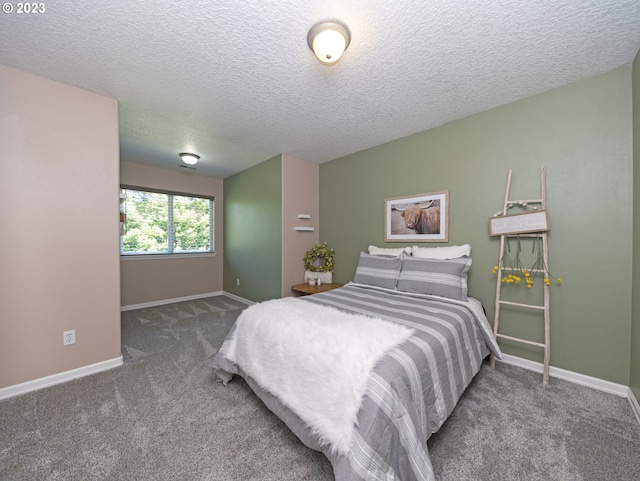 bedroom with a textured ceiling and carpet flooring