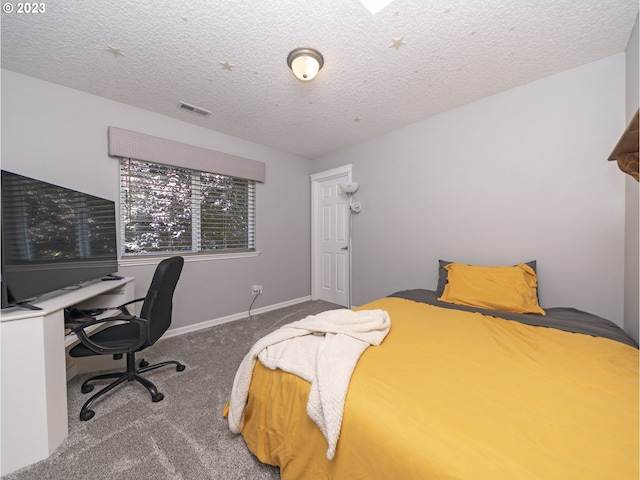 bedroom with a textured ceiling and carpet floors