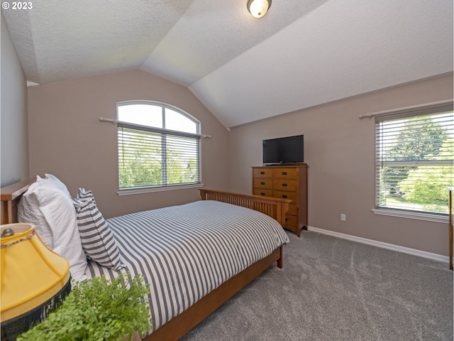 bedroom featuring a textured ceiling, carpet flooring, and vaulted ceiling