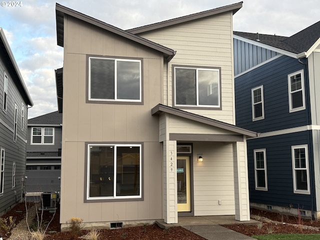 view of front of house featuring crawl space, a garage, central AC unit, and board and batten siding