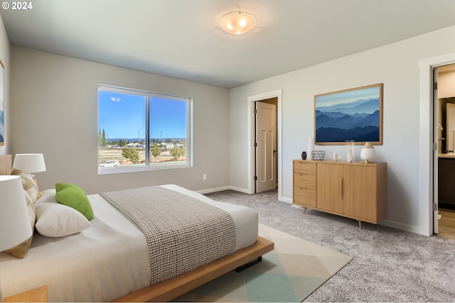 bedroom with baseboards and light colored carpet