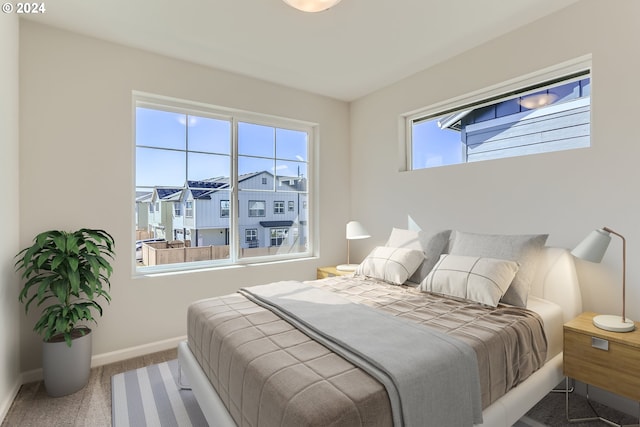 bedroom featuring carpet and baseboards