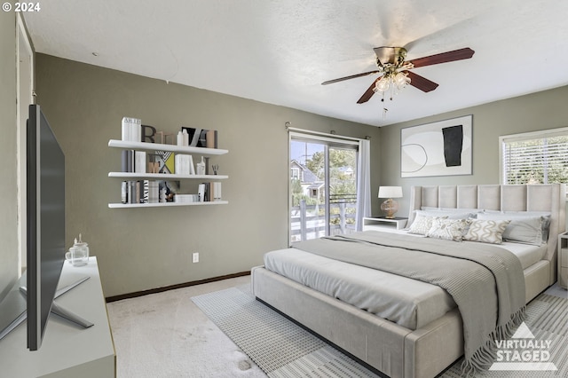 carpeted bedroom featuring a textured ceiling, access to outside, and ceiling fan