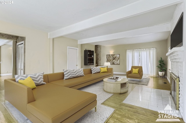 living room with beam ceiling and light hardwood / wood-style flooring