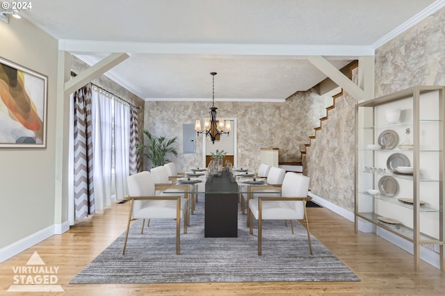 dining area with hardwood / wood-style flooring, a chandelier, and ornamental molding