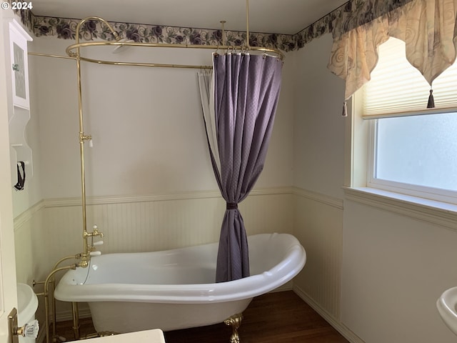 bathroom featuring hardwood / wood-style floors and separate shower and tub