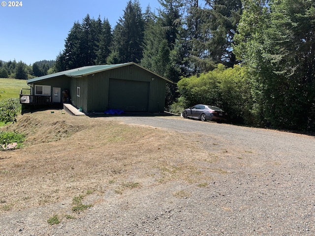 view of side of property with an outdoor structure and a garage