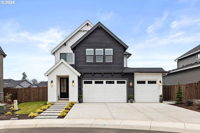 modern inspired farmhouse featuring a front lawn and a garage