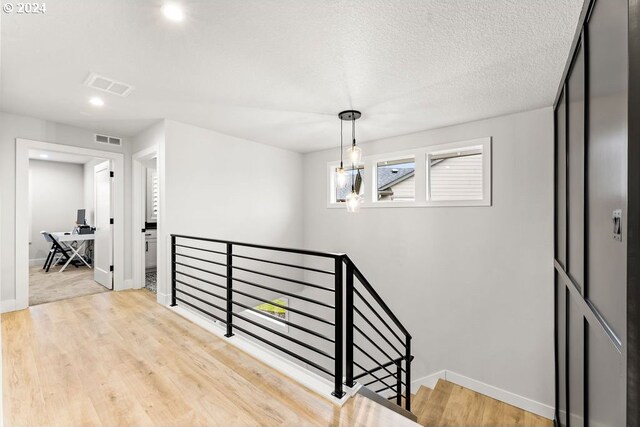 bedroom with ensuite bathroom and light wood-type flooring