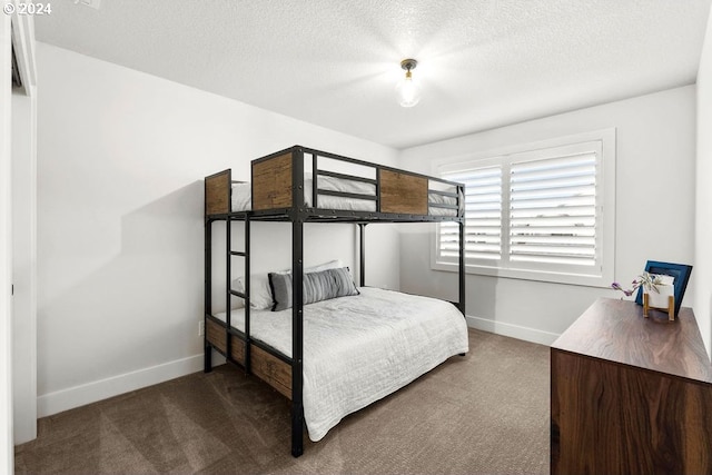 carpeted bedroom featuring a textured ceiling