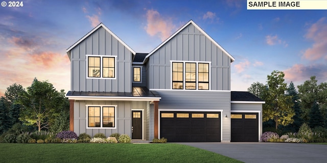 modern farmhouse featuring a lawn and a garage