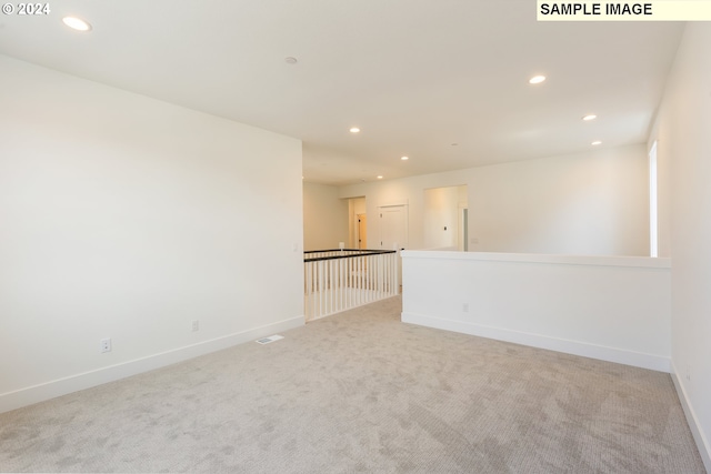 spare room with light colored carpet