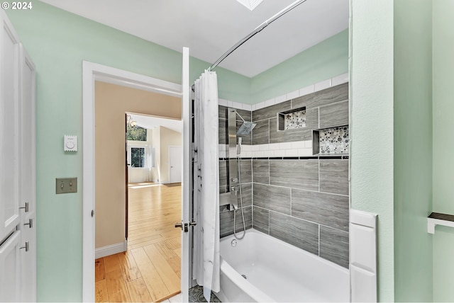 bathroom featuring shower / bath combination with curtain and hardwood / wood-style flooring