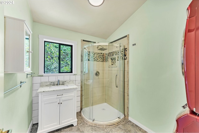 bathroom with vanity, an enclosed shower, and lofted ceiling