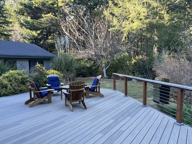 wooden deck with an outdoor fire pit