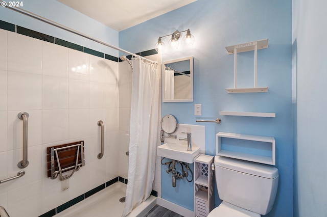 bathroom with a shower with shower curtain, toilet, and sink