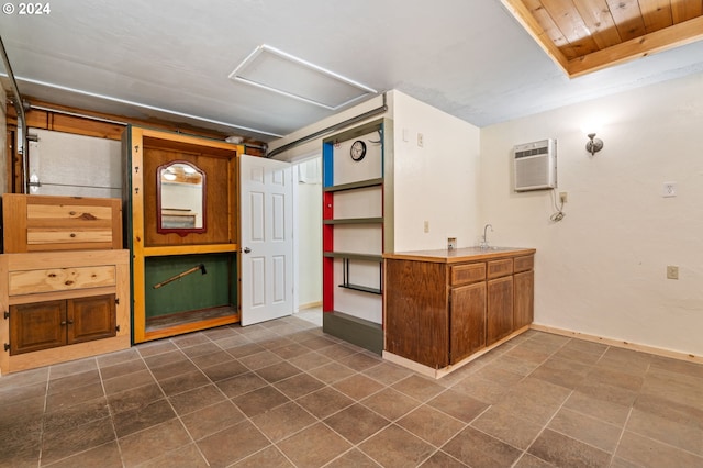 basement with a wall unit AC, wood ceiling, and sink