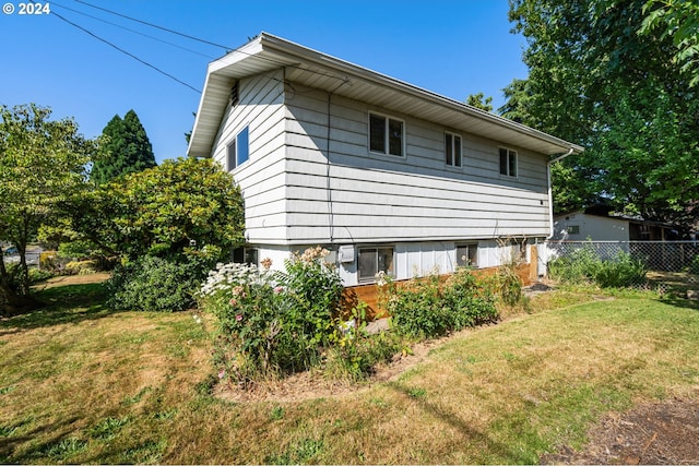 view of side of property featuring a yard