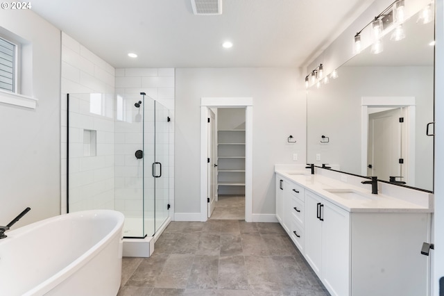 bathroom featuring vanity and shower with separate bathtub